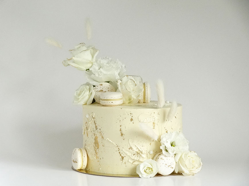 Beautiful white & gold wedding cake with flowers