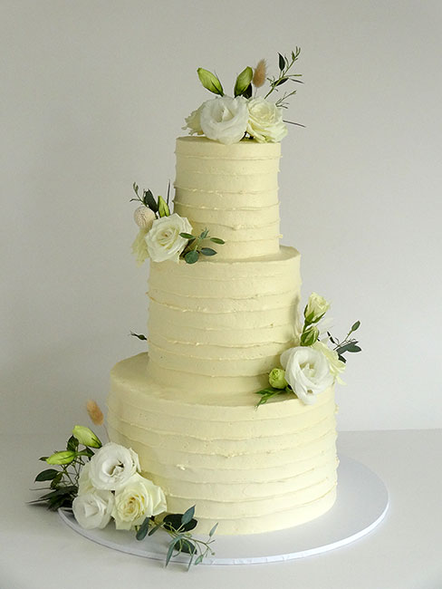 Large 3-tier wedding cake with fresh flowers