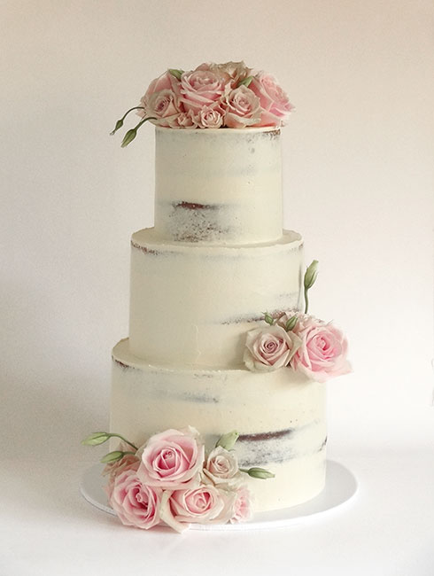 3-tier half-naked wedding cake with pink roses